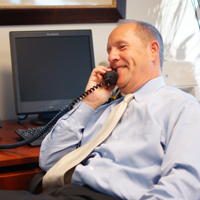 Jeffrey Sleeper sitting talking on landline phone
